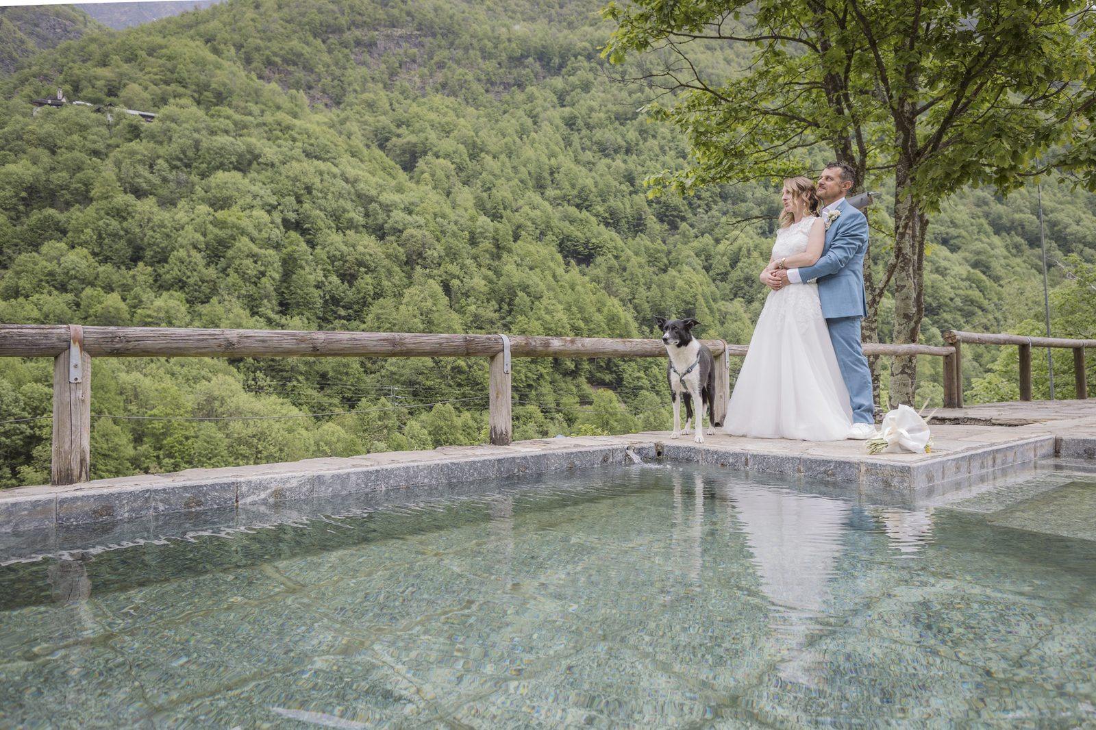 The newlyweds by the natural pool overlooking the valley