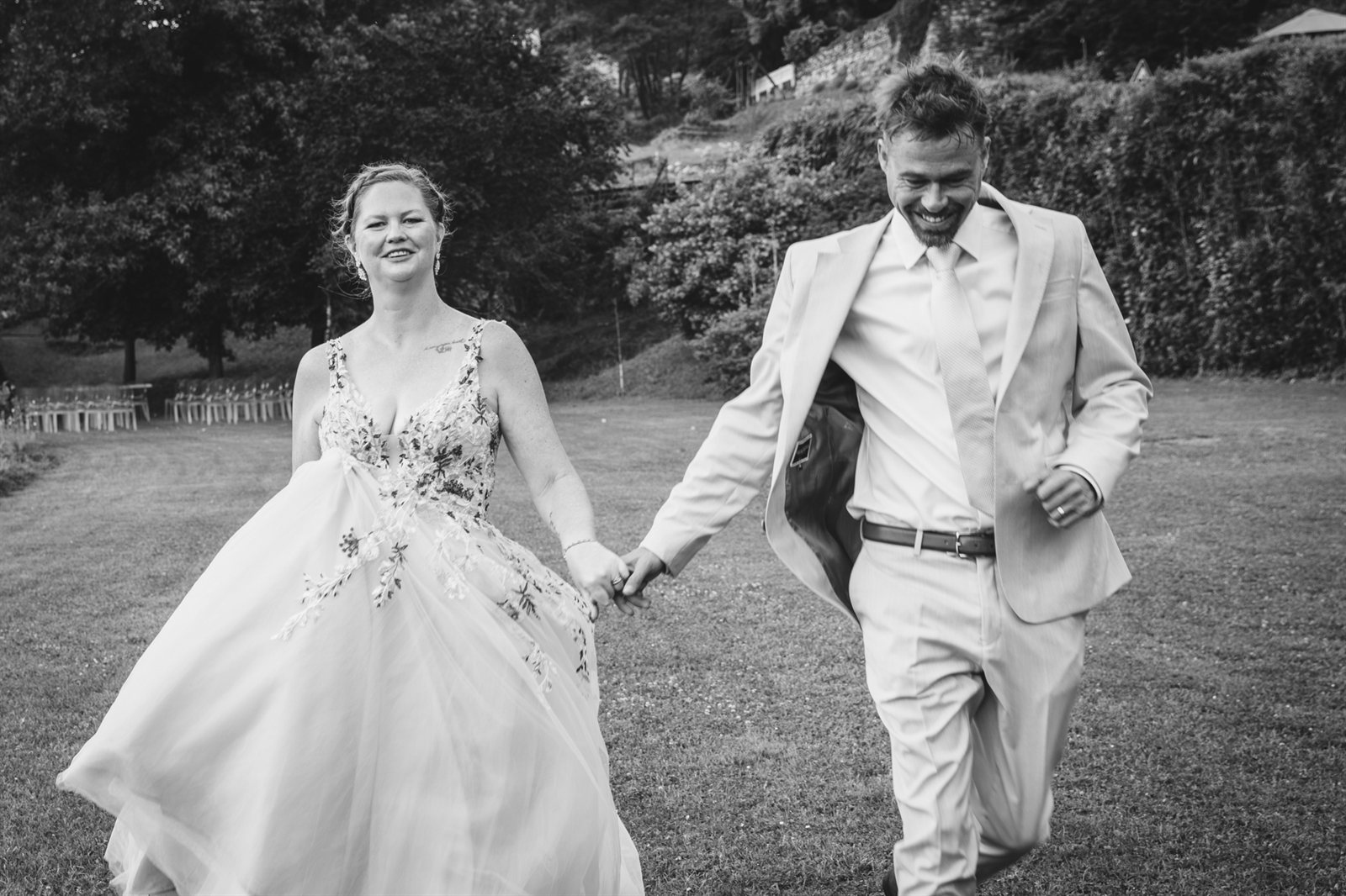 The newlyweds on the lawn, hand in hand, black and white