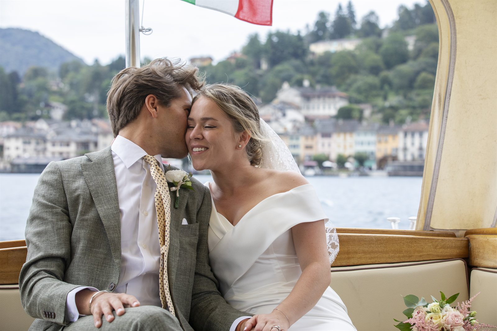 The couple on the boat on the lake, the village behind them