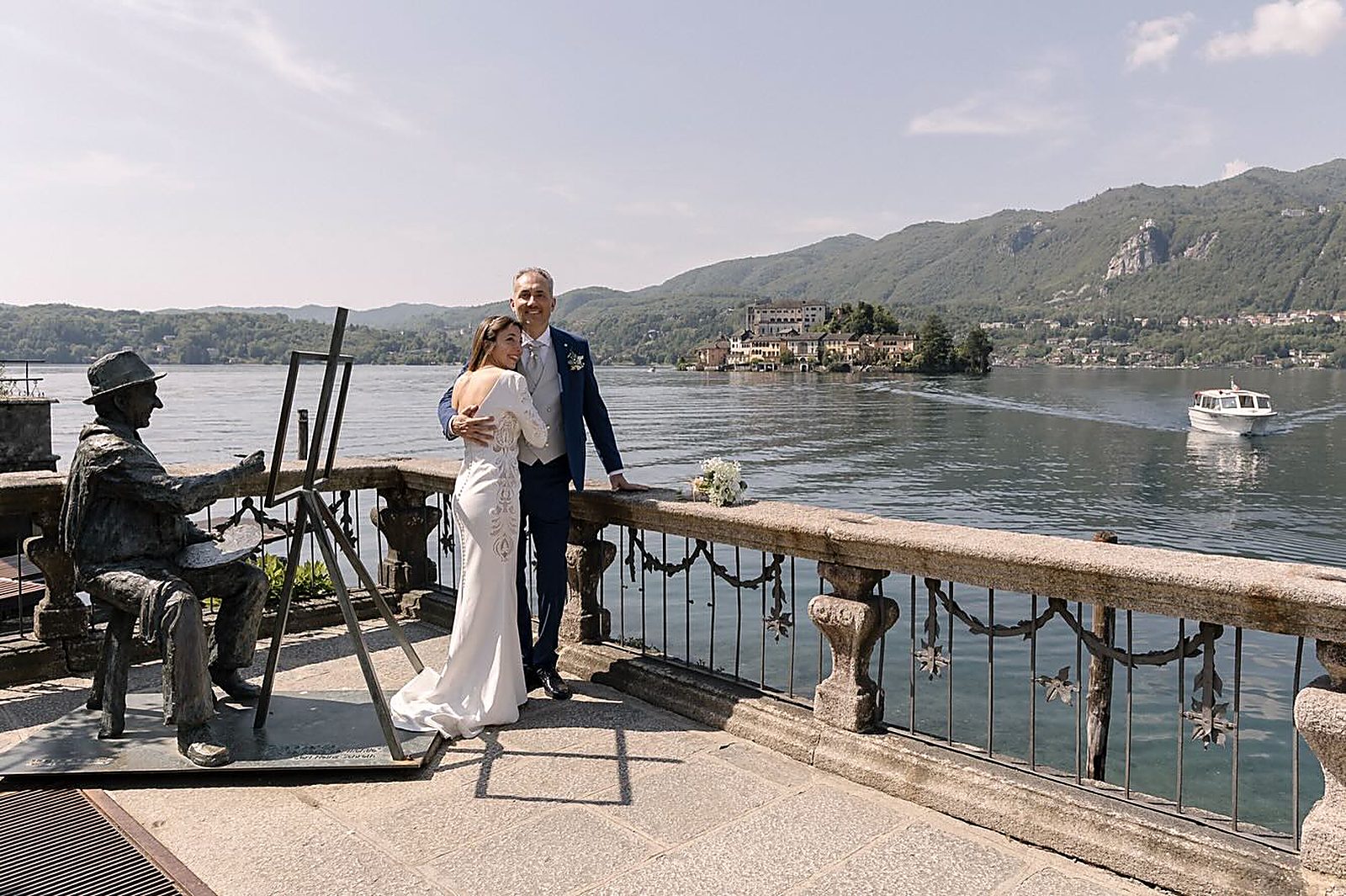 Gli sposi abbracciati alla balaustra, l'Isola di San Giulio alle spalle Gli sposi abbracciati alla balaustra, l'Isola di San Giulio alle spalle