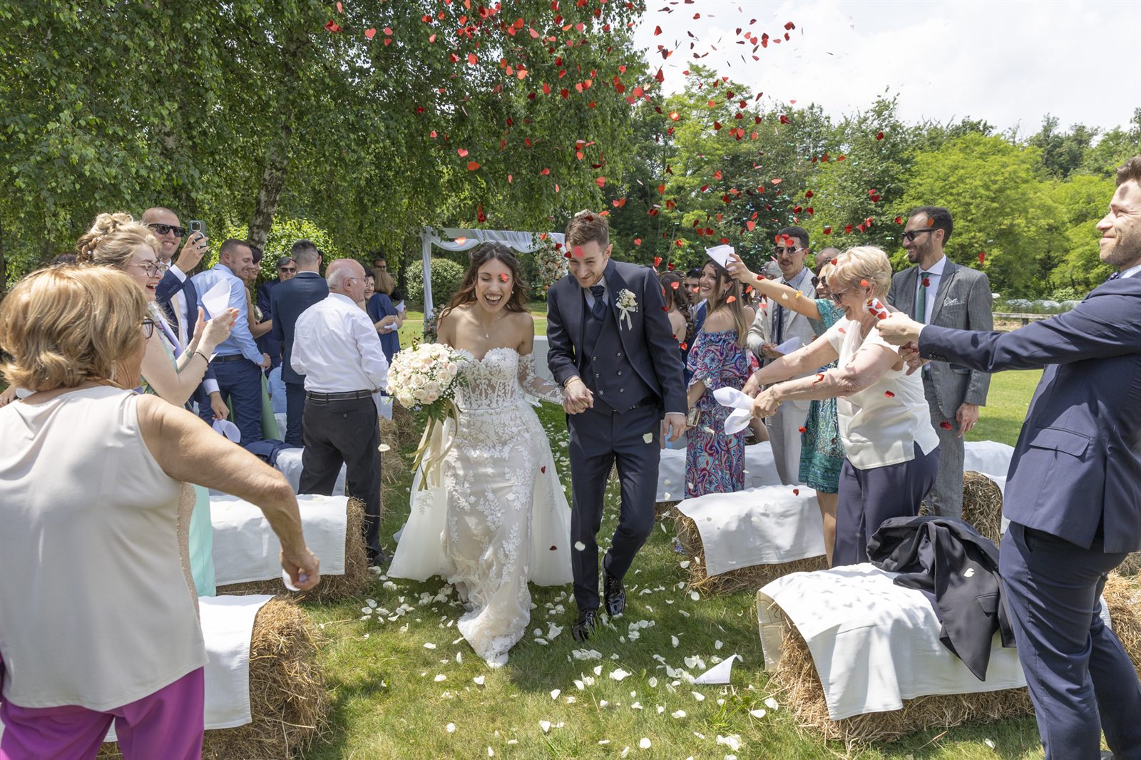 Leaving the ceremony under a shower of petals