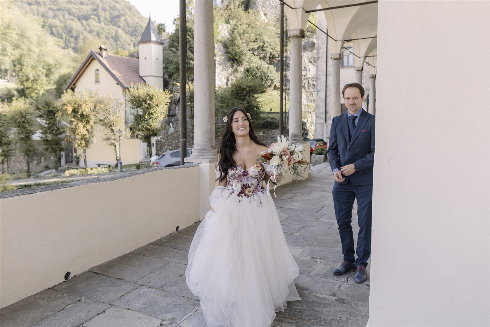 La sposa accompagnata lungo il porticato della chiesa La sposa accompagnata lungo il porticato della chiesa