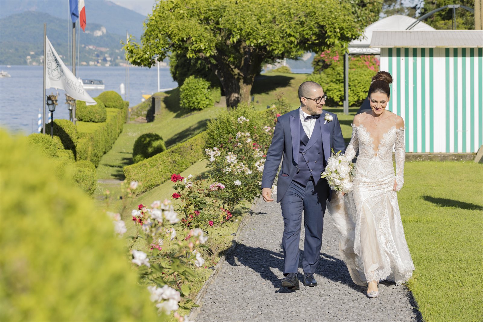 The couple in the villa's garden, among the shaped hedges